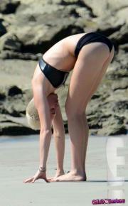 Miley-Cyrus-bending-over-in-a-bikini-20686-2.jpg image hosted at ImgTaxi.com