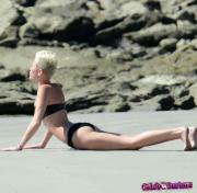 Miley-Cyrus-bending-over-in-a-bikini-20686-3.jpg image hosted at ImgTaxi.com