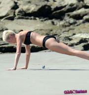 Miley-Cyrus-bending-over-in-a-bikini-20686-4.jpg image hosted at ImgTaxi.com