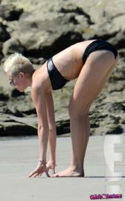 Miley-Cyrus-bending-over-in-a-bikini-20686-11.jpg image hosted at ImgTaxi.com